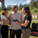 Friends learning safe shooting with instructor