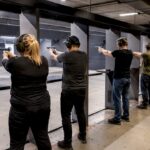 Adults shooting safely indoors at modern range
