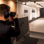 Shooter measuring distance indoors with laser rangefinder