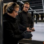 Visitor preparing hands at indoor shooting range