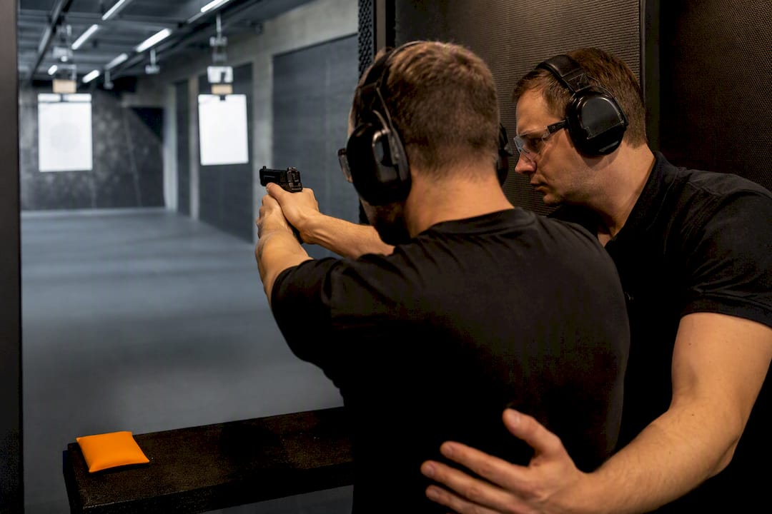 Instructor supervising controlled handgun follow-up shots
