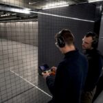 Instructor supervising indoor drone safety practice