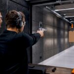 Instructor supervising magnum pistol handling indoors