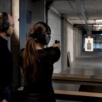 Instructor supervising indoor shooting course practice