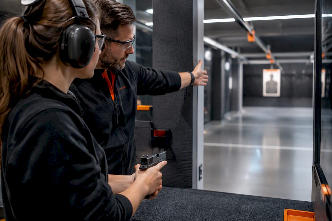 Instructor checking shooter safety equipment
