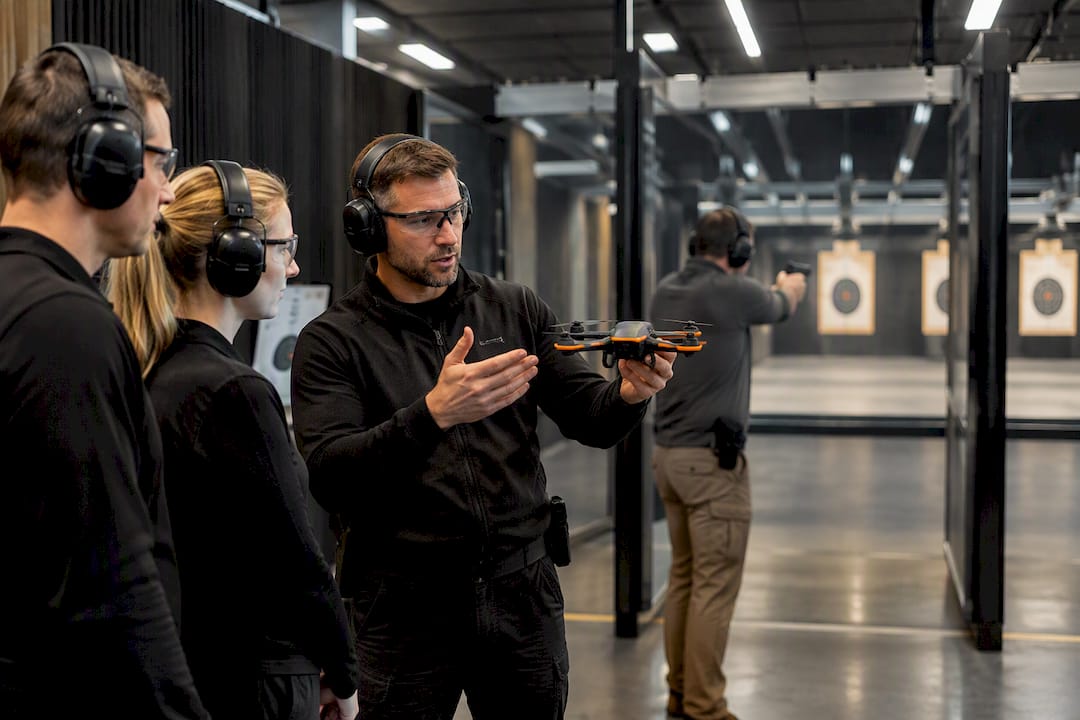 Instructor demonstrating drone during indoor corporate range event
