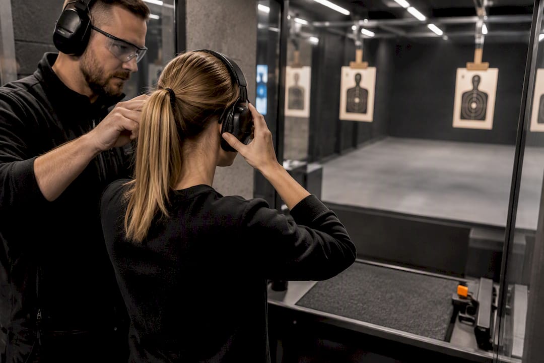 Visitor preparing protective gear at shooting range