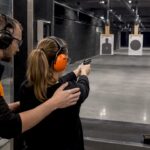 Beginner receiving supervised indoor range instruction