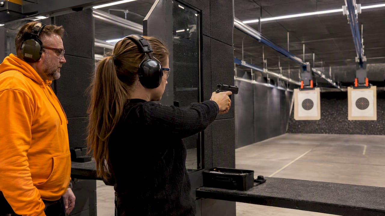 Instructor supervising safe firearm handling