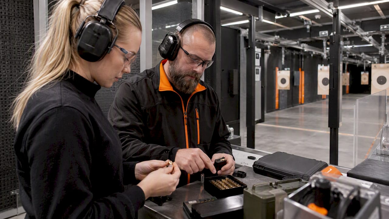 Instructor supervising ammunition preparation at the range