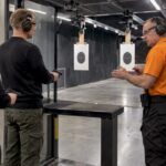 Visitors listen to an instructor at the firing line
