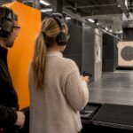 Instructor supervises visitor at electronic target lane