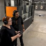 Instructor supervises indoor drone pilot training